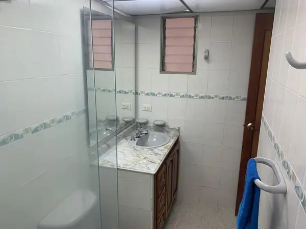 Baño con ducha de vidrio y mueble de lavamanos